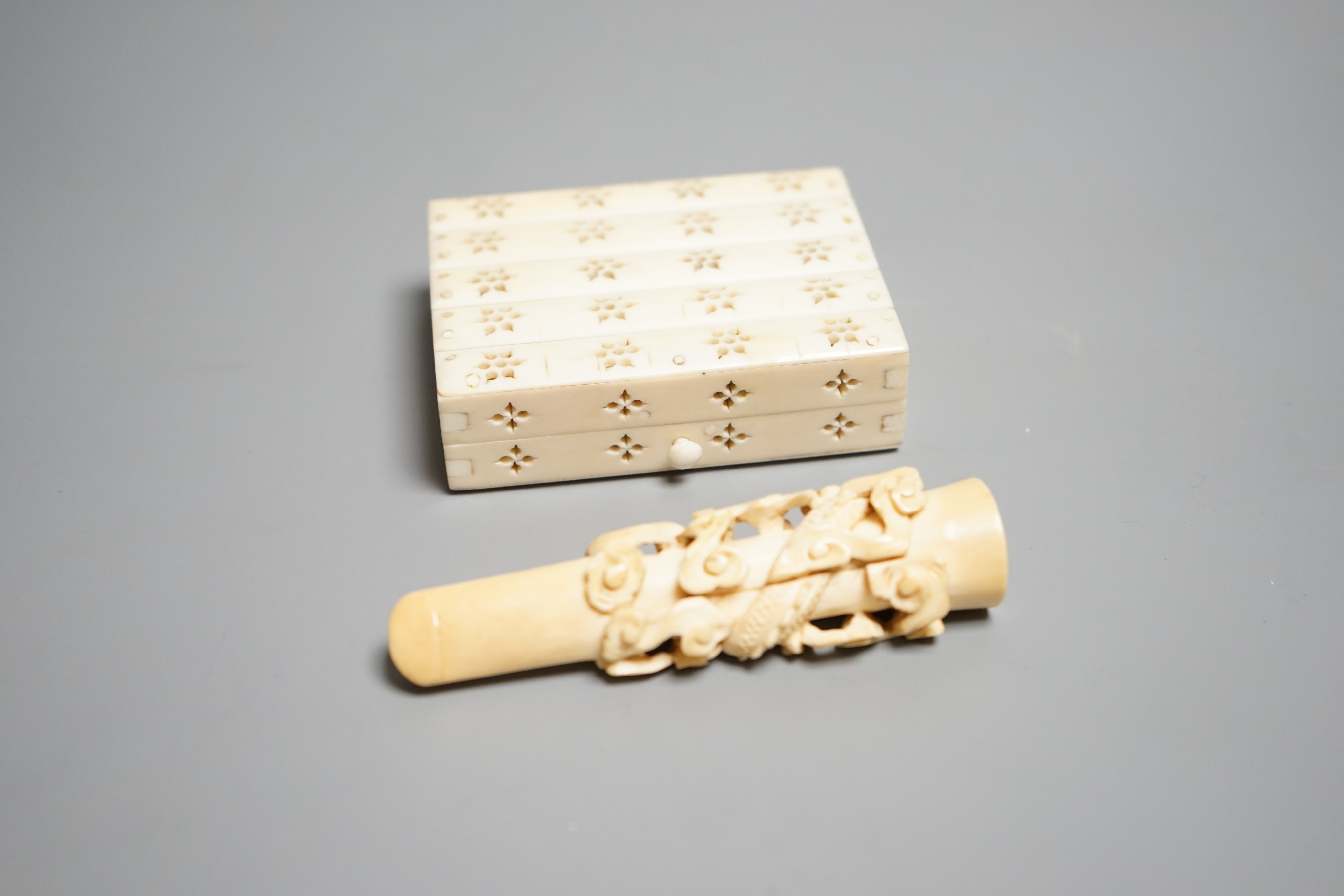 A Chinese ivory cigarette case, 8 x 6cm, and a Chinese carved ivory cheroot holder